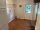 Functional laundry room with wood-look flooring, providing a practical space for household chores at 7494 Flat Creek Rd, Lancaster, SC 29720
