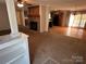 Open-concept living area showcasing a brick fireplace, hardwood floors, and seamless transition to the kitchen at 7494 Flat Creek Rd, Lancaster, SC 29720
