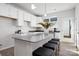 Bright kitchen with a large island, black seating, white cabinets, and gray countertop at 8118 Jacey Ln # 20, Huntersville, NC 28078