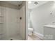 Clean bathroom with vinyl flooring, a walk-in shower, and neutral decor at 842 Murphy St, Kannapolis, NC 28081