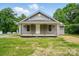 Charming single-story home with a welcoming front porch and gray siding at 842 Murphy St, Kannapolis, NC 28081