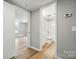 Hallway leading to a bathroom and bedroom, with neutral tones and vinyl flooring at 842 Murphy St, Kannapolis, NC 28081