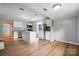 Well-lit kitchen featuring an island, stainless steel appliances, and wood-look vinyl flooring at 842 Murphy St, Kannapolis, NC 28081