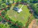 An aerial showcases a property with a long drive, separate garage, and perimeter outlined in pink at 945 Songbird St, Lancaster, SC 29720