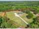 A serene aerial view shows a home with an expansive, well-maintained lawn bordered by lush trees at 945 Songbird St, Lancaster, SC 29720