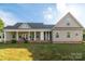 Exterior view of a house showcasing a covered porch and manicured lawn at 945 Songbird St, Lancaster, SC 29720