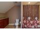 Cozy bathroom highlighting a toilet and shower with a decorative floral curtain at 945 Songbird St, Lancaster, SC 29720
