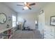 Bright, carpeted bedroom features neutral walls, with a ceiling fan and white furnishings at 945 Songbird St, Lancaster, SC 29720