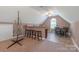Cozy bonus room including a bar with stools, a ceiling fan, and natural light at 945 Songbird St, Lancaster, SC 29720