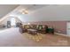 Spacious bonus room with plush carpet, a large sectional couch, and a ceiling fan at 945 Songbird St, Lancaster, SC 29720