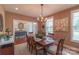 Inviting dining room featuring a wooden table set for a meal, with natural light and stylish decor at 945 Songbird St, Lancaster, SC 29720