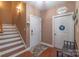 Inviting entryway with hardwood floors, staircase, and coat closet at 945 Songbird St, Lancaster, SC 29720