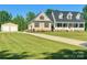 Charming home boasts a two-car garage, well-maintained lawn, and classic architectural details under a clear blue sky at 945 Songbird St, Lancaster, SC 29720
