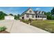 Scenic view of a home with a two-car garage, lush green lawn, and colorful landscaping on a sunny day at 945 Songbird St, Lancaster, SC 29720