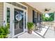 Cozy porch featuring rocking chairs, a decorative door, potted plants, and a ceiling fan for comfort at 945 Songbird St, Lancaster, SC 29720