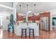 Charming kitchen with cherry cabinets, breakfast bar, stainless steel appliances, and hardwood flooring at 945 Songbird St, Lancaster, SC 29720