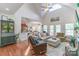 Cozy living room features vaulted ceiling, wood floors, and view into the kitchen at 945 Songbird St, Lancaster, SC 29720