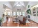 Bright living room with a vaulted ceiling, fireplace, built-in shelving, and an open layout connected to the kitchen at 945 Songbird St, Lancaster, SC 29720