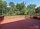 View of a large back deck overlooking private backyard with wooded acreage at 9565 Man O War Rd, Indian Land, SC 29707