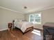 Bedroom featuring hardwood floors, a large window with view of the property, and natural light at 9565 Man O War Rd, Indian Land, SC 29707