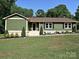 Charming single-story home featuring green siding, dark shutters, and a well-manicured lawn at 9565 Man O War Rd, Indian Land, SC 29707