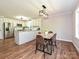 Eat in kitchen with stainless appliances, granite countertops, and modern lighting fixtures at 9565 Man O War Rd, Indian Land, SC 29707