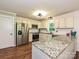 Bright eat in kitchen featuring stainless appliances, granite countertops, and white cabinetry at 9565 Man O War Rd, Indian Land, SC 29707