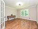 Bright living room with hardwood floors, a classic console table, and lots of natural light at 9565 Man O War Rd, Indian Land, SC 29707