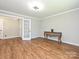 Living room with hardwood floors, traditional console table, and paneled walls at 9565 Man O War Rd, Indian Land, SC 29707
