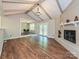 Cozy living room with hardwood floors, a brick fireplace, and vaulted ceilings at 9565 Man O War Rd, Indian Land, SC 29707