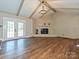 Inviting living room with a white brick fireplace, vaulted ceiling, and French doors at 9565 Man O War Rd, Indian Land, SC 29707