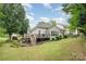 Beautiful backyard with deck, manicured shrubs and luscious lawn at 10011 Spring Park Dr, Charlotte, NC 28269