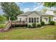 Backyard featuring deck, luscious lawn and lovely white home at 10011 Spring Park Dr, Charlotte, NC 28269