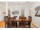 Dining room with hardwood floors, wood table and view to kitchen and living areas at 10011 Spring Park Dr, Charlotte, NC 28269