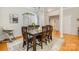 Open dining room with wood table, seating for six, hardwood floors, and natural lighting at 10011 Spring Park Dr, Charlotte, NC 28269