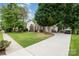 Well-maintained home on lush lot with long driveway leading to garage and backyard deck at 10011 Spring Park Dr, Charlotte, NC 28269