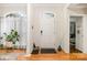 Bright foyer with wood floors, transom window, and plant at 10011 Spring Park Dr, Charlotte, NC 28269