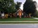 Charming brick home with a lush green lawn, mature trees, and inviting curb appeal at 10011 Spring Park Dr, Charlotte, NC 28269