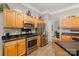 Kitchen featuring stainless steel appliances, granite countertops, and beautiful oak cabinets at 10011 Spring Park Dr, Charlotte, NC 28269