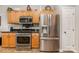 Kitchen featuring stainless steel appliances, wood cabinets, and black countertops at 10011 Spring Park Dr, Charlotte, NC 28269