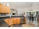 Open kitchen layout with stainless dishwasher and black countertops; view to dining and living area at 10011 Spring Park Dr, Charlotte, NC 28269