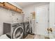 Well-equipped laundry room features modern washer and dryer, shelving and tile flooring at 10011 Spring Park Dr, Charlotte, NC 28269