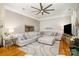 Bright living room featuring a large sectional sofa, accent rug and ceiling fan at 10011 Spring Park Dr, Charlotte, NC 28269