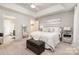 Spacious main bedroom featuring tray ceilings, carpet, and ensuite bathroom at 10011 Spring Park Dr, Charlotte, NC 28269
