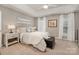 Bright main bedroom with tray ceilings, soft carpet, and a leather bench at 10011 Spring Park Dr, Charlotte, NC 28269