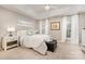 Bright main bedroom with tray ceilings, soft carpet, and a leather bench at 10011 Spring Park Dr, Charlotte, NC 28269