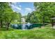 Community pond with fountain, bench and covered grill at 10011 Spring Park Dr, Charlotte, NC 28269