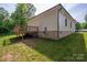 Side view of the house with a wooden deck, green lawn, and brick foundation at 1012 W Carroll St, Cherryville, NC 28021