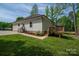View of the home's backyard showcasing a small deck, green lawn, and white siding at 1012 W Carroll St, Cherryville, NC 28021