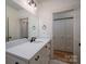 Bathroom featuring white vanity with black hardware and framed mirror at 1012 W Carroll St, Cherryville, NC 28021
